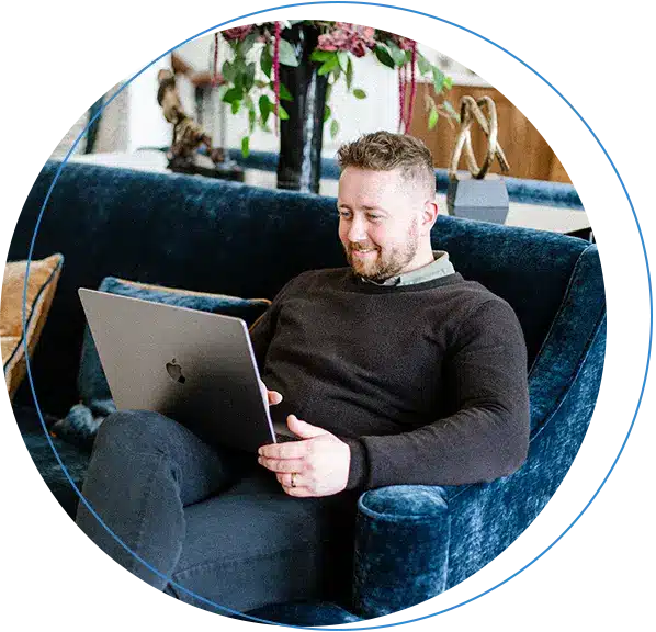 Ryan Weir Sitting on Laptop at VINDICTA Digital marketing agency's head office in Belfast